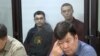Жоомарт Дуулатов и Александр Александров. На переднем плане: один из их адвокатов