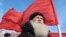 Russia -- A demonstrator with a red Soviet flag stands during a protest rally in Barnaul city in Altai region, 24Mar2010