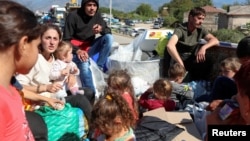 Armenia - Refugees from Nagorno-Karabakh sit in the back of a truck upon their arrival in the border village of Kornidzor, September 27, 2023.