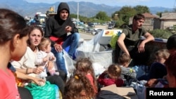 Armenia - Refugees from Nagorno-Karabakh sit in the back of a truck upon their arrival in the border village of Kornidzor, September 27, 2023.
