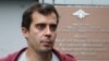 Roman Dobrokhotov leaves a police station in Moscow following questioning in July.