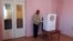A person helping an elderly woman to vote in Armenian local elections last year.