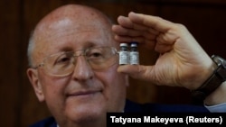 Aleksandr Gintsburg, director of the Gamaleya National Research Center, holds bottles with the Sputnik-V vaccine in Moscow in September.