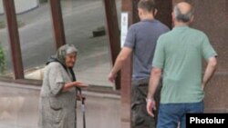 Armenia -- An elderly woman begs for money in Yerevan.