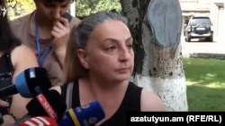 A woman who is looking for answers about the fate of her son who went missing during last year’s hostilities in Nagorno-Karabakh talks to media near the National Security Service building in Yerevan, Armenia, on August 19, 2021. 