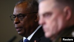 U.S. Secretary of Defense Lloyd Austin (left) and the chairman of the U.S. Joint Chiefs of Staff, General Mark A. Milley, speak to reporters in Germany on January 20.