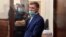 Khabarovsk Governor Sergei Furgal stands inside a defendants' cage during a court hearing in Moscow on July 10. 