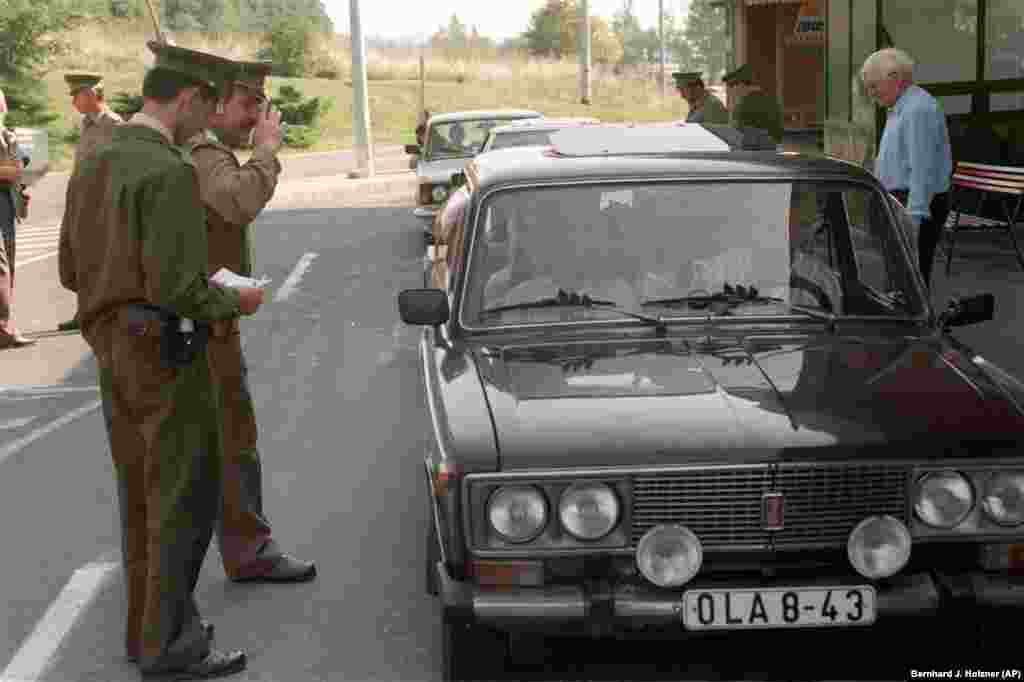 A Hungarian customs officer checks passports belonging to East Germans on September 11.