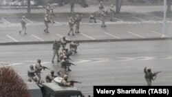 Security forces are seen being sued against anti-government protests in Almaty on January 6.