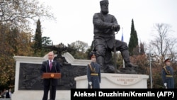 Russian President Vladimir Putin (left) delivers a speech during the unveiling ceremony of a monument to Tsar Aleksandr III in Yalta, Crimea, on November 18.