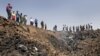 Iran -- Iranians gather the edge of a crater at the crash site of the Caspian Airlines plane, 15Jul2009