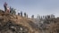 Iran -- Iranians gather the edge of a crater at the crash site of the Caspian Airlines plane, 15Jul2009