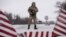 A Ukrainian guard stands ready at the border in Milove.