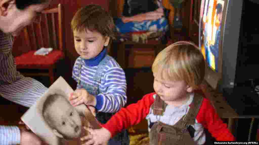 Діти Івана Яцкіна розглядають дитячу фотографію батька. Дома в Криму на Івана чекають четверо дітей, а зовсім скоро на світ з&#39;явиться і п&#39;ята дитина. &nbsp; Як живе родина Івана Яцкіна без батька, сина і чоловіка &ndash; дивіться у нашій фотогалереї