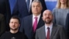  Ukrainian President Volodymyr Zelenskiy (left) and Hungarian Prime Minister Viktor Orban (top) pose for a family photo next to European Council President Charles Michel at the European leaders summit in Brussels on February 9.