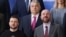  Ukrainian President Volodymyr Zelenskiy (left) and Hungarian Prime Minister Viktor Orban (top) pose for a family photo next to European Council President Charles Michel at the European leaders summit in Brussels on February 9.