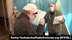 Избиратель читает фамилии в бюллетене, Бахмут, иллюстративное фото