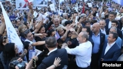 Armenia - Former President Robert Kocharian shakes hands with supporters during an election campaign rally in Yerevan's Nor Nork district, June 9, 2021.