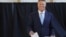 Romanian President Klaus Iohannis casts his vote in a May 26 referendum on changes to the country's judiciary and anti-corruption legislation. 