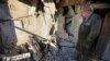 A man examines a damaged apartment building after shelling in Donetsk city on December 15. 