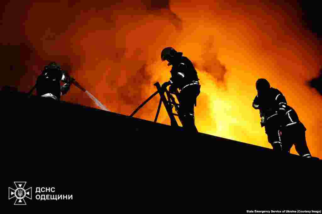 Firefighters work at the site of a strike on the southern city of Odesa early on November 25.Odesa was also hit overnight with strikes that injured six people, including two children according to Ukraine's State Emergency Service.