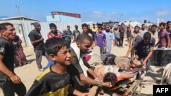 Gaza - Palestinians transport victims to a Red Cross clinic in Rafah after being reportedly shot as they waited to receive food parcels at a distribution point run by the Gaza Humanitarian Foundation, July 12, 2025.