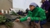 A woman lights candles in Almaty on February 13 in memory of those killed, 40 days after the January unrest.