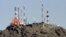 Looking higher: telecoms towers on a hilltop above Kabul