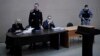 A video feed from the penal colony shows Aleksei Navalny (standing) during the court hearing in the town of Pokrov last month.