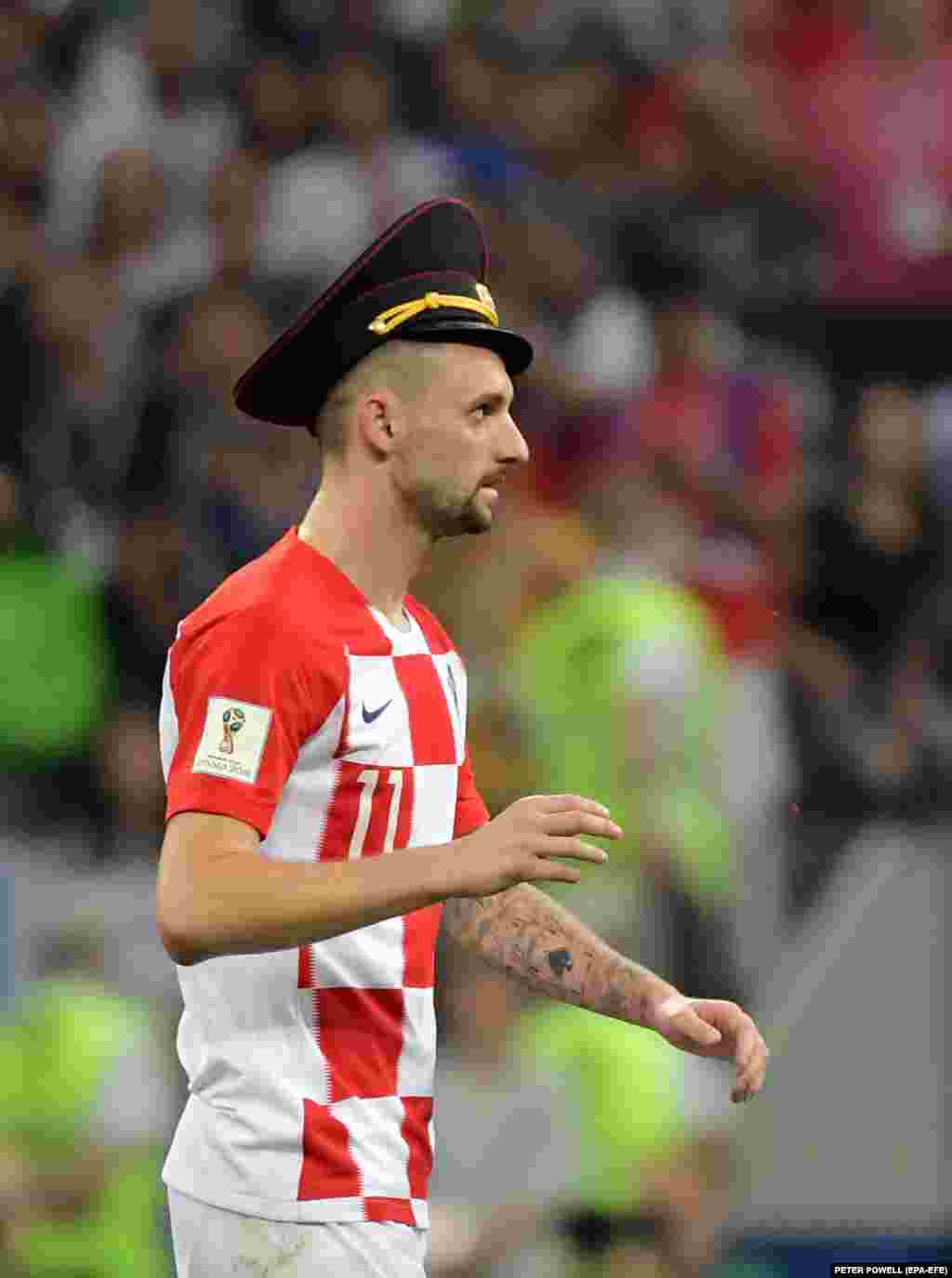 Marcelo Brozovic of Croatia wearing the hat of one of the pitch invaders.&nbsp;