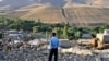 Iran -- A man looks at damaged houses in the earthquake-stricken village of Varzaqan near Ahar, in East Azerbaijan province, 12Aug2012