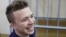 Journalist Roman Pratasevich in a defendant's cage in Minsk during a court hearing in 2017. 