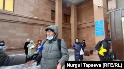 Dauytbek Moldabaev speaks to a reporter in front of the presidential administration building in Nur-Sultan on February 24.