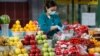 Kazakhstan -  vendor wearing a protective face mask following an outbreak of the coronavirus disease (COVID-19) pack vegetables at a local food market, also known as bazaar, in Almaty, Kazakhstan March 20, 2020. REUTERS/Pavel Mikheyev