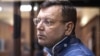 The director of the Listvyazhnaya coal mine, Sergei Makhrakov, seen inside a defendant's cage in a courtroom in Kemerovo on November 27, is accused of violating industrial safety rules that led to the deaths of the miners.