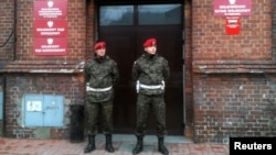 Poland -- Military police stand guard outside the military prosecutor's office in Poznan, 09Jan2012