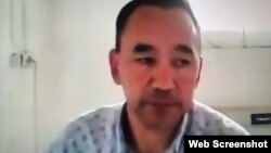 Activist Erbol Eskhozhin is seen during his trial, which was held online.
