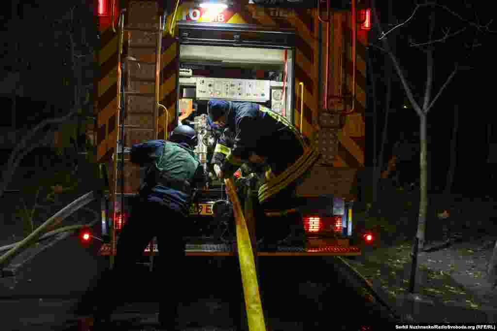 Firefighters work at the scene of the Dniprovskiy district strike.Ukrainian rescue personnel have repeatedly been targeted by "double tap" strikes that hit firefighting vehicles.