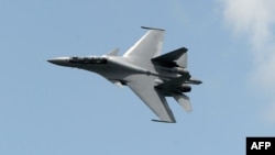 Singapore -- A Sukhoi SU-30 fighter jet from the Royal Malaysian Air Force performs a slow fly past during the Singapore Airshow at Changi exhibition center in Singapore, February 16, 2016