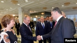 Президент В. Путин (солдон экинчи) президент П. Порошенко  менен саламдашууда. ЕБнын тышкы иштер комиссары К. Эштон (солдон биринчи) жана казак президенти Н. Назарбаев (ортодо). Минск, 26-август