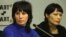 Bakiya Kasymova (left) and Leila Ashirova, both recently freed from captivity, talk to reporters in connection with a recent "slavery" scandal involving migrant workers in Moscow.