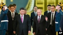 Russian President Vladimir Putin (center right) welcomes his Chinese counterpart, Xi Jinping (center left), for talks at the Kremlin in June. 