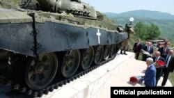 Armenian President Serzh Sarkisian (foreground) lays flowers during Victory Day celebrations in Stepanakert on May 9.