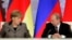 Ангела Меркель (л) и Владимир Путин (п)