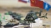 Miniatures depicting troops of different nations sit on a plan for SCO military exercises in 2010.