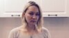 Yelena Balanovskaya stands in the newly decorated kitchen of the apartment that she bought with a dollar mortgage that she's now struggling to pay off because of the ruble crisis.