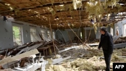 Nagorno-Karabakh -- A man walks inside a destroyed building in the village of Talish, some 80km north of Karabakh's capital Stepanakert, April 6, 2016