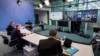 Ukrainian President Volodymyr Zelenskiy appears on a screen as German Chancellor Olaf Scholz (second left) oversees a virtual G7 leaders meeting at the Chancellery in Berlin on October 11.