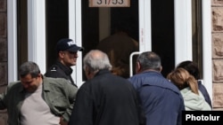 Armenia - Voters enter a polling station in Gyumri, March 30, 2025.