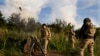 Ukrainian soldiers fire mortars toward Russian positions at the front line near Bakhmut in the Donetsk region on June 30